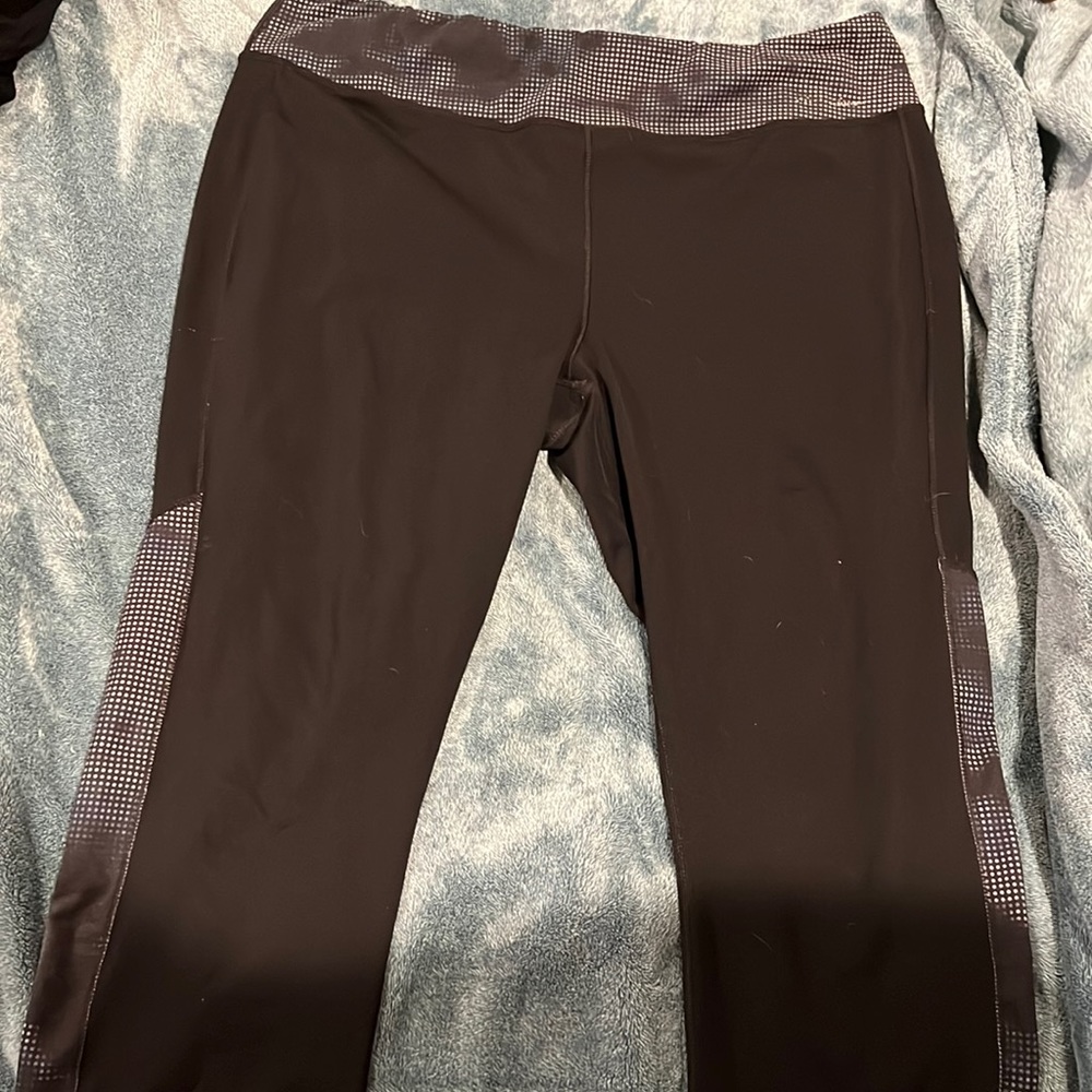 Black capris leggings with blue and white dots on waist band and on side of legs